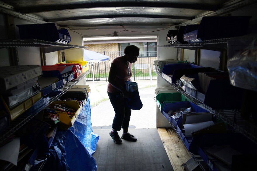 A Dayspring Head Start employee chooses school supplies in the back of the Supply Mobile box truck.