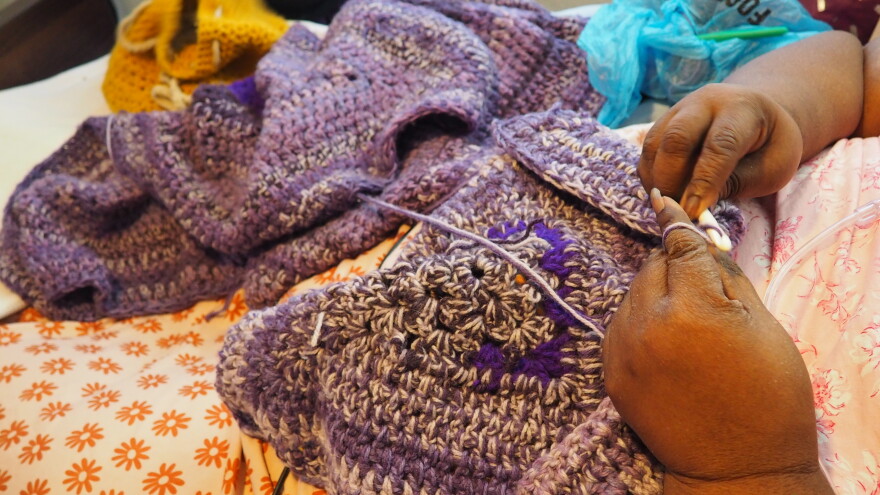 DeBorah Montague crochets a blanket. Her lease ended in April, but she can't find a new place to live. Her eviction hearing is in October.