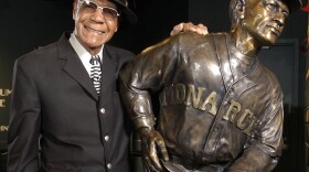 Buck O'Neil stands with a statue of himself in the Negro League Baseball Museum in Kansas City, Mo., in February 2005. O’Neil, a champion of Black ballplayers during a monumental career on and off the field, has joined Gil Hodges, Minnie Minoso and three others in being elected to the baseball Hall of Fame on Dec. 5, 2021. (Charlie Riedel/AP/File)