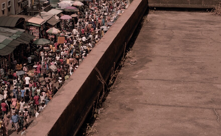 The gray-pink Sahara sand that blankets every surface of the abandoned Financial Trust building is a haunting contrast to the teeming market of Lagos Island.