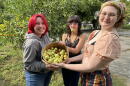 Kansas City Academy students Peper Wilson, Alex Ledford, and Nova Henry are showing off a basket of jujubes freshly picked from trees the Giving Grove helped the school plant and maintain.