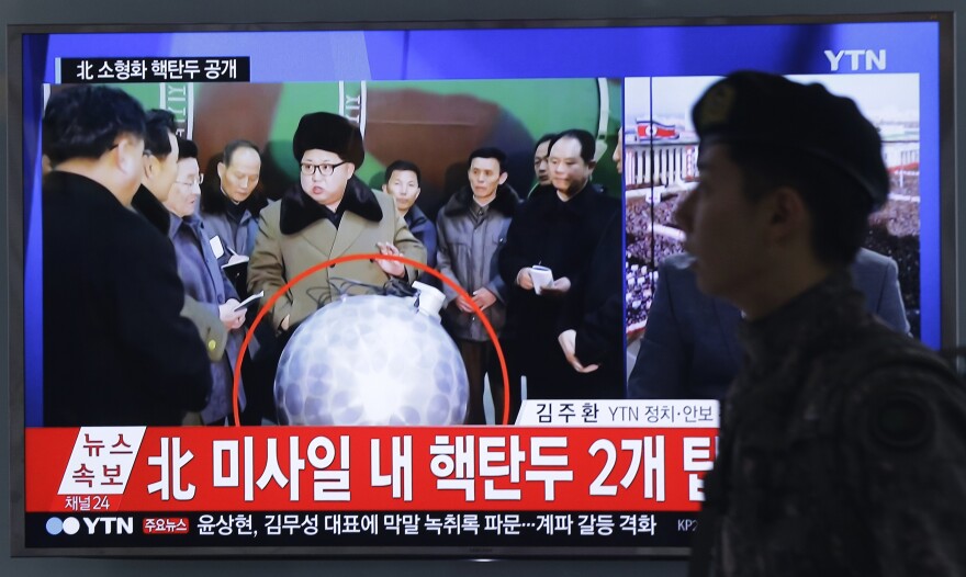 A South Korean army soldier walks by a TV screen in March showing North Korean leader Kim Jong Un with superimposed letters that read: "North Korea's nuclear warhead."
