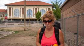 Carlee Faust, who has been homeless in Salt Lake City for about a year, stands in front of a recently fenced-off area on 500 West behind the old Rio Grande Depot on Sept. 20, 2023. Many homeless people used to live in the area, including some of her friends.