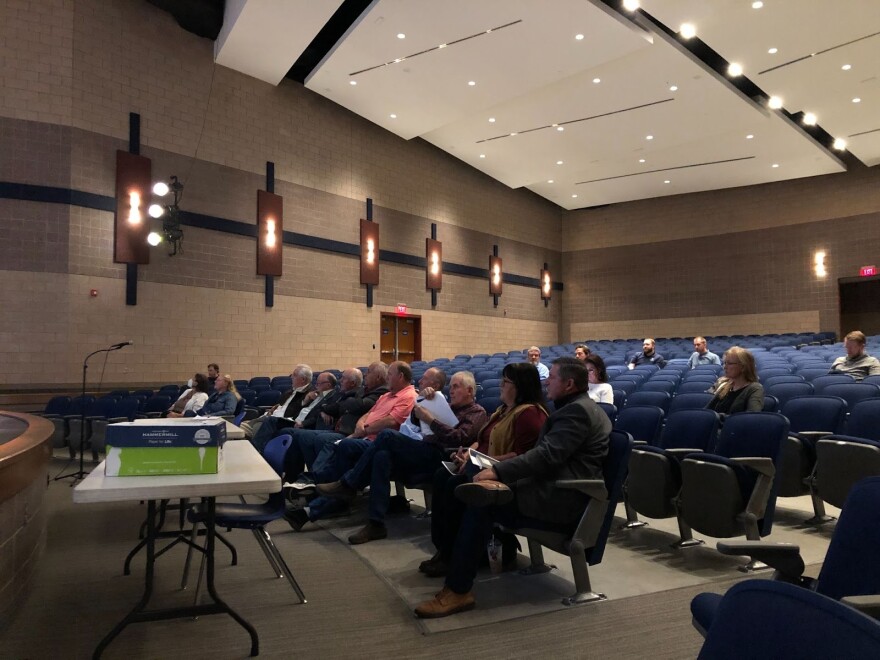 A photo of a meeting in an auditorium.