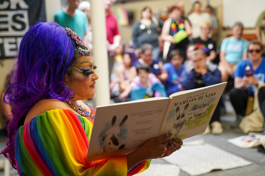 Sassy Sascha reads "A Day in the Life of Marlon Bundo" to families at Colors+ Youth Center.