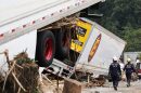 A close-up of an 18-wheeler that came lose with debris around it
