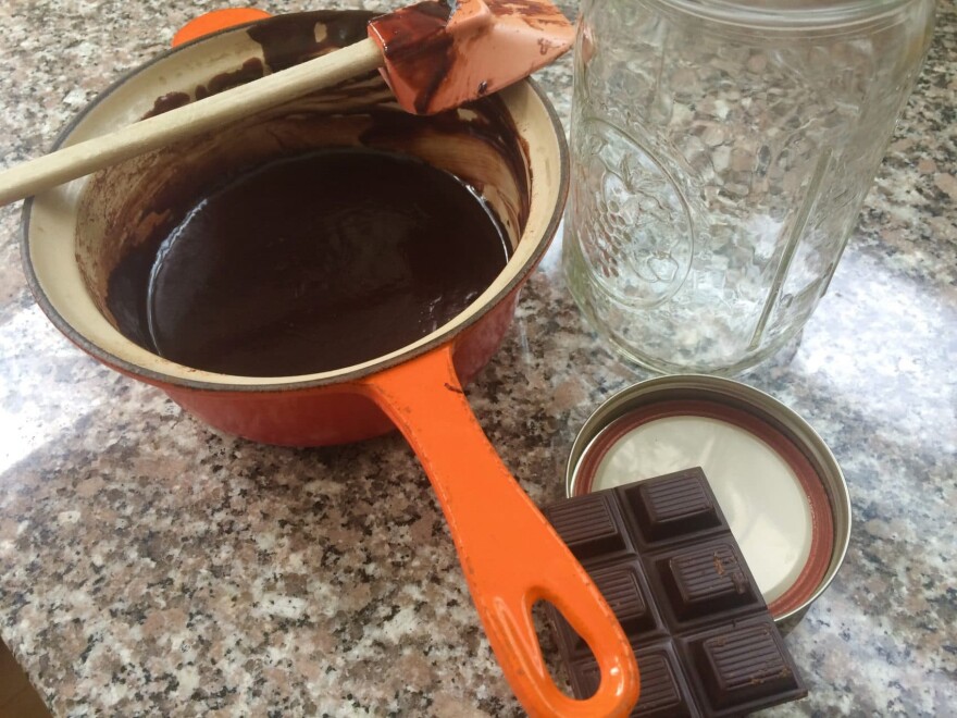 A pot containing melted dark chocolate, the key ingredient for Kathy's hot fudge sauce. (Kathy Gunst for Here & Now)