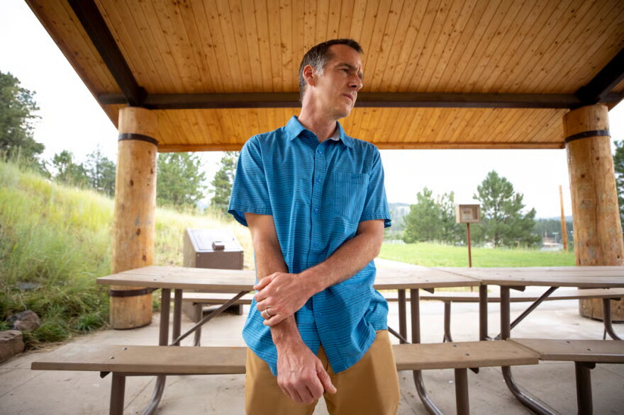 Fritz Krembs, the parent of an Evergreen High School student, stands in a recreation shelter near the school. Aug. 10, 2026.