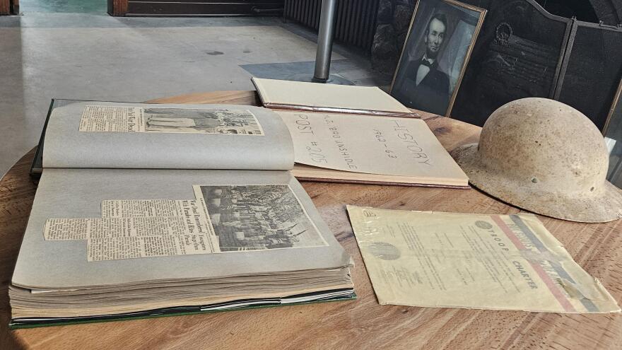 Books at Milton J. Brounshidle Post No. 205 document the American Legion post's history from 1958-59, left, and '62-63, as well as a helmet from around the period of World War I.