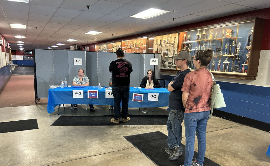 Voters wait in line to check in on Primary Election Day, Aug. 11, 2026, at the Chisholm Sports Arena complex. In addition to statewide races, Chisholm voters were narrowing the field among mayoral candidates.