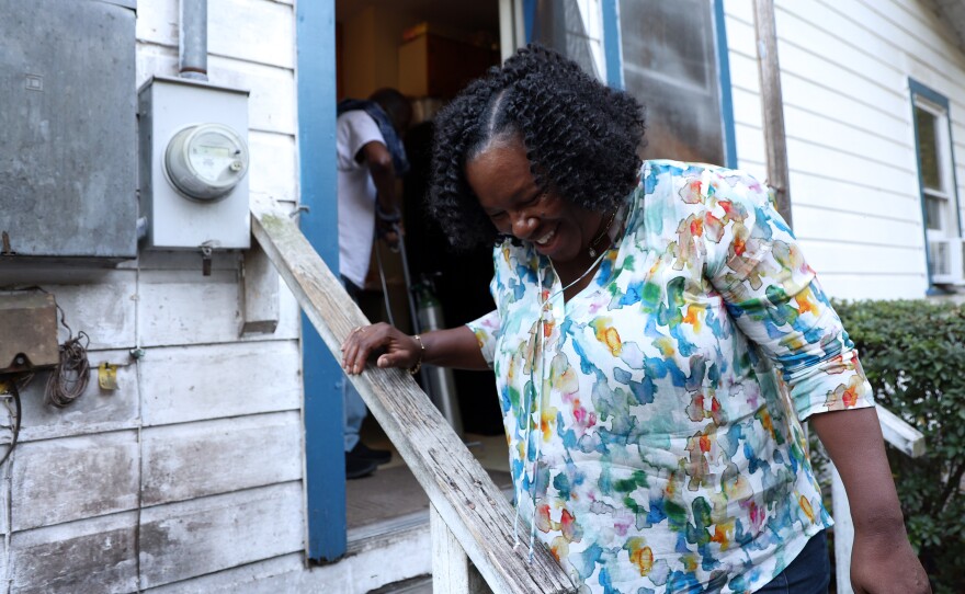 Jaquelyn “Jackie” King, a rideshare driver for the company Uber, helps rider Jimmy Rochelle into his home in Micanopy, Fla.., on Thursday, Nov. 20, 2025.
