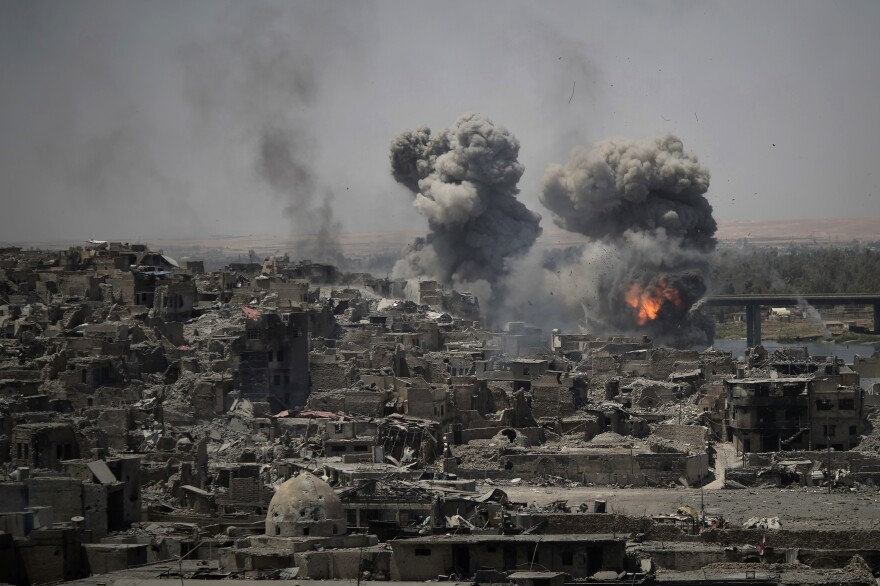 Airstrikes target Islamic State positions on the edge of the Old City on Tuesday, a day after Iraq's prime minister declared "total victory" in Mosul, Iraq.