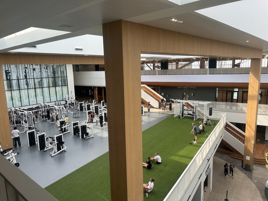 Students work out in the MSU Student Recreation and Wellness Center's weight room and turf area.