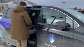 A micro transit van picking up a rider.