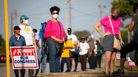 Harris County residents wait in line at Houston's Bayland Community Center during the first day of early voting.