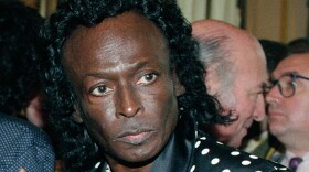 FILE - In this July 16, 1991 file photo, jazz great Miles Davis is pictured after receiving the Chevalier de la Legion d'Honneur award medal from the French government in Paris. Davis wasn't even listed in the program book when he appeared for the first time at the Newport Jazz Festival in 1955, but he made his presence felt with a career-reviving performance in an all-star jam session. This year's program book is Miles-centric as the festival, which begins July 31, celebrates the 60th anniversary of the late jazz legend's historic Newport debut. (AP Photo/Remy de la Mauviniere, File)