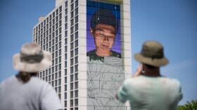 Artists Michael Rice (right) and Chris Gann (left) step back across I-84 on May 15, 2023 to look at their mural in progress. At approximately 18 stories high, they said it's the only time they can really see the whole piece as it's meant to be seen.