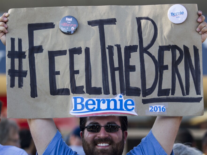 Frank Rothstein holds a "Feel the Bern" sign before a rally Bernie Sanders in Los Angeles that drew tens of thousands. The phrase has become an anti-establishment rallying cry for Sanders fans.