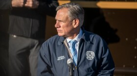 Gov. Greg Abbott listens at a press conference in Austin on Dec. 17. 