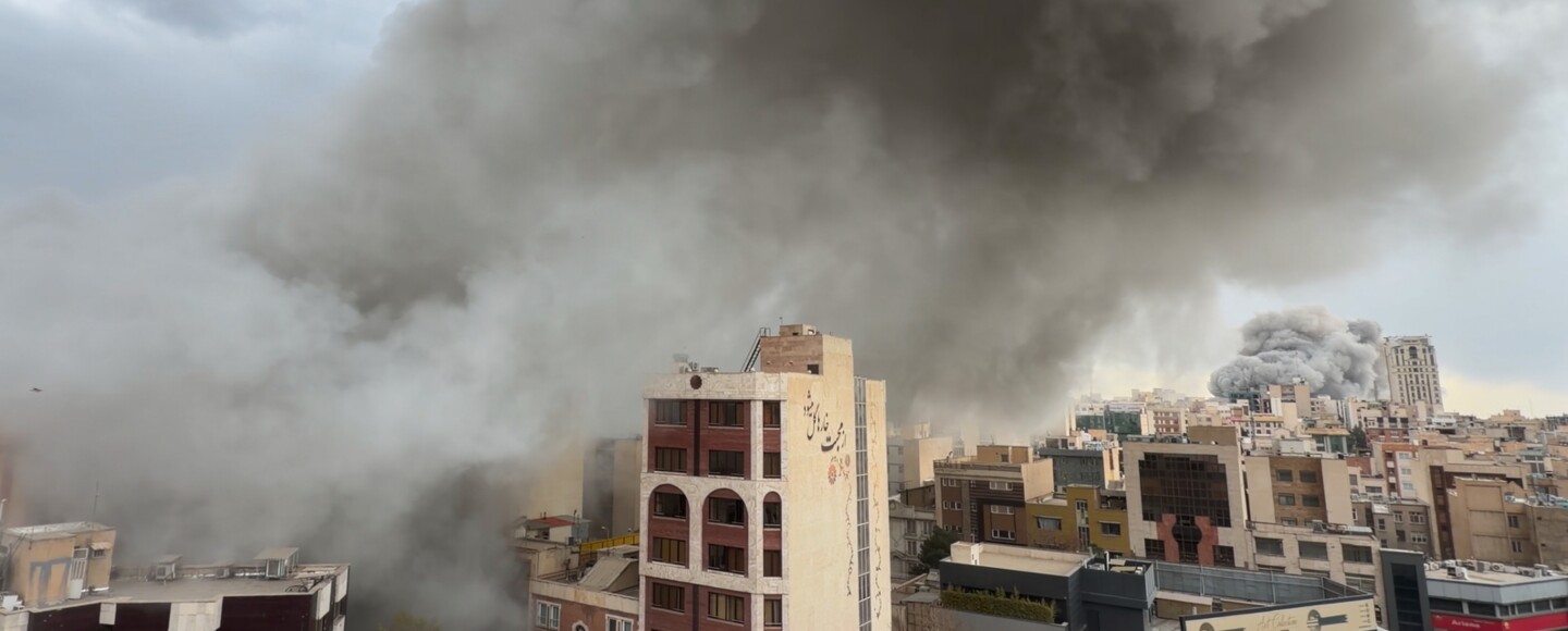 Plumes of smoke from two simultaneous strikes rise over Tehran, Iran, Monday, March 2, 2026.