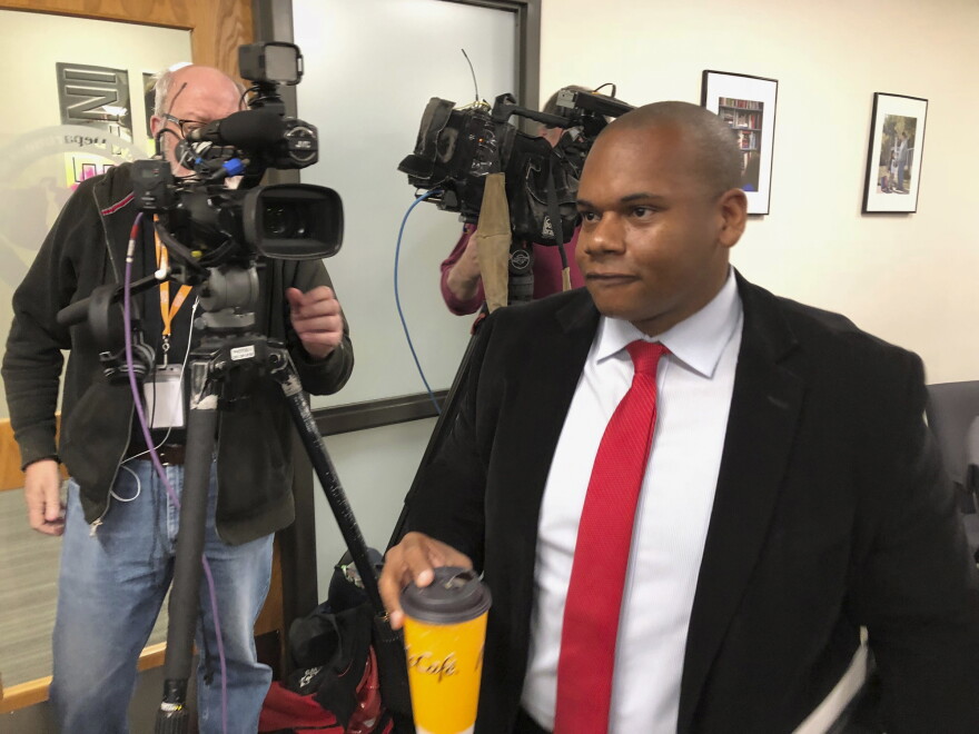 Kentucky Education Commissioner Wayne Lewis walks past reporters on Thursday, Dec. 12, 2019, in Frankfort, 
