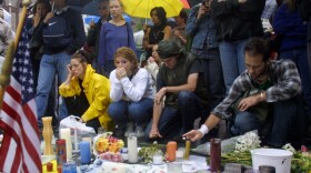 People mourn the victims of the World Trade Center disaster at a memorial in Union Square Park in New York City.