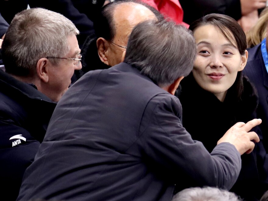 Kim Yo Jong has captured attention during her visit to the Pyeongchang Winter Olympics. Here, South Korea's President Moon Jae-in speaks to Kim as International Olympic Committee President Thomas Bach looks on, at the first game of the unified Korean women's hockey team Saturday.