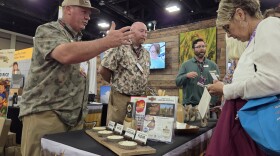 Tommy Wheeler, founder and owner of Tidewater Grains, speaks with school nutrition professionals about his company's rice products at the Charlotte Convention Center.