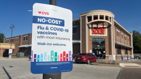 A sign offering no-cost flu and COVID vaccines with insurance at a CVS in Kansas City, Missouri.