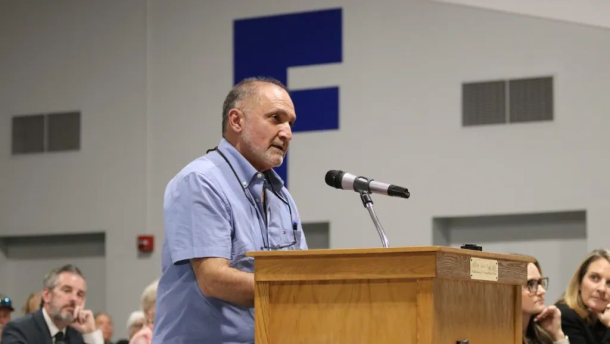 Photo of Darius Assemi at a podium during a hearing.