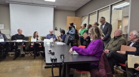 Lansing Planning Commission members listen to a masked resident express her concerns over a plan to build a data center near downtown.