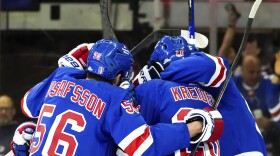 New York Rangers defenseman Erik Gustafsson (56), left wing Jimmy Vesey and others celebrate center Vincent Trocheck's goal against the Carolina Hurricanes during the first period in Game 1 of an NHL hockey Stanley Cup second-round playoff series, Sunday, May 5, 2024, in New York. (AP Photo/Julia Nikhinson)