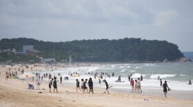People enjoy a beach in Boryeong, South Korea, Saturday, July 25, 2026.