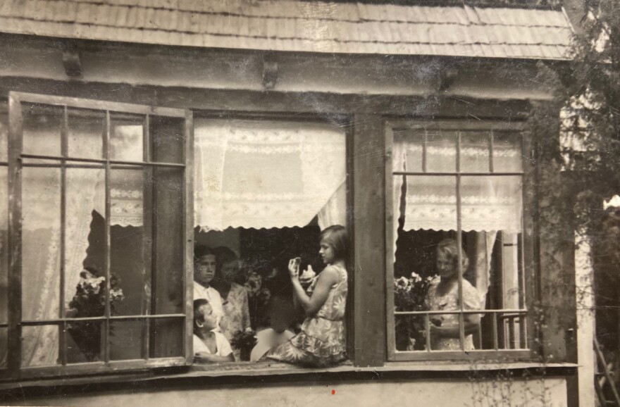 Maiga Zalinskis (center, on window sill) as a young girl in Latvia