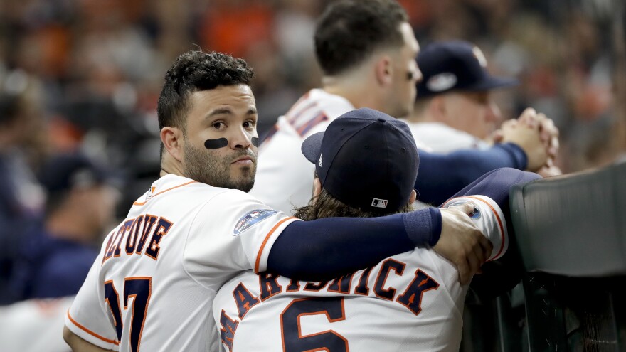 The Houston Astros' Jose Altuve and Jake Marisnick watch from the dugout on Thursday. Houston won the 2017 World Series but fell just short this season.