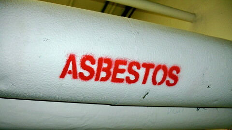 Pipes with white insulation wrap are labeled "asbestos" in red. 