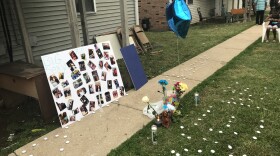 Candles and photos mark a memorial for one of the victims of the June 10th shootings of four people on Orchard Road in Bloomington.