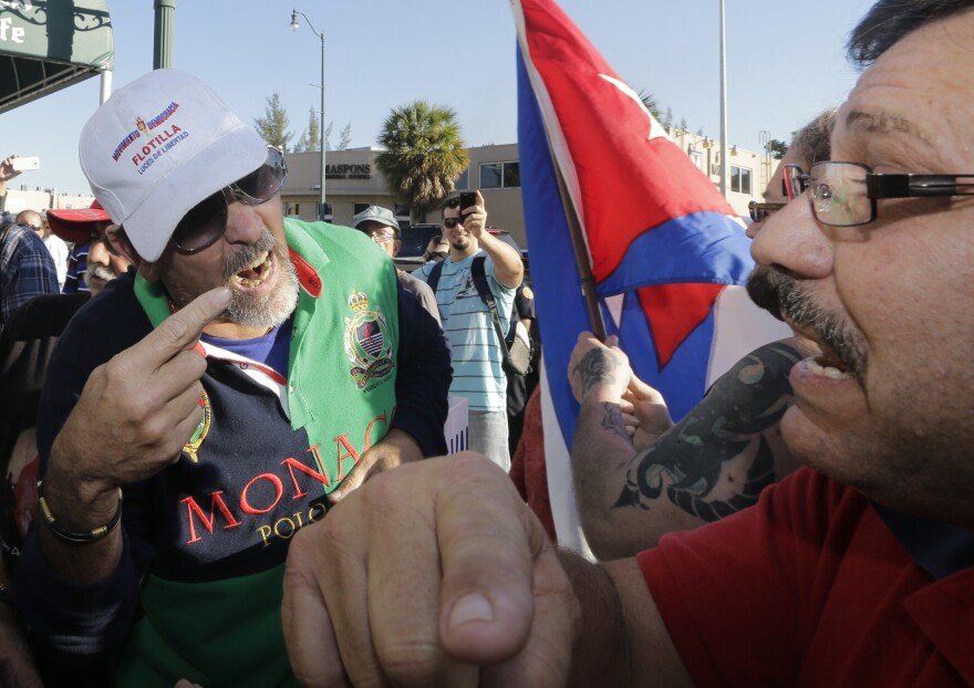 Anti-Castro protester Lazaro Lozano (left) argues with an unidentified pro-Obama supporter in the Little Havana area of Miami on Wednesday.