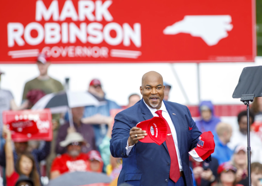 North Carolina Lt. Governor Mark Robinson tosses caps to supporters following a rally announcing he is officially running for Governor during a rally outside Ace Speedway in Elon, N.C. Saturday, April 22, 2023. (Photo courtesy of Lynn Hey for WUNC)