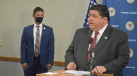 Illinois Gov. JB Pritzker, right, speaks at the Peoria City/County Health Department on July 30, 2020.