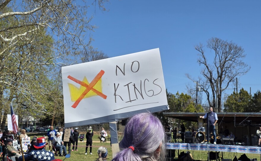 A protester holds up a sign reading "NO KINGS" at Tulsa's third "No Kings" rally on March 28, 2026.