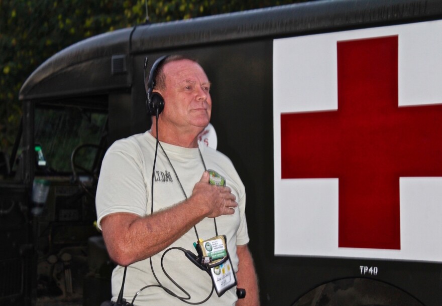 Dan McCluskey, the convoy commander, pauses for the National Anthem.