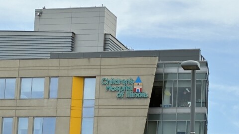 A photo of the top corner of a hospital, taken from the ground and looking up.