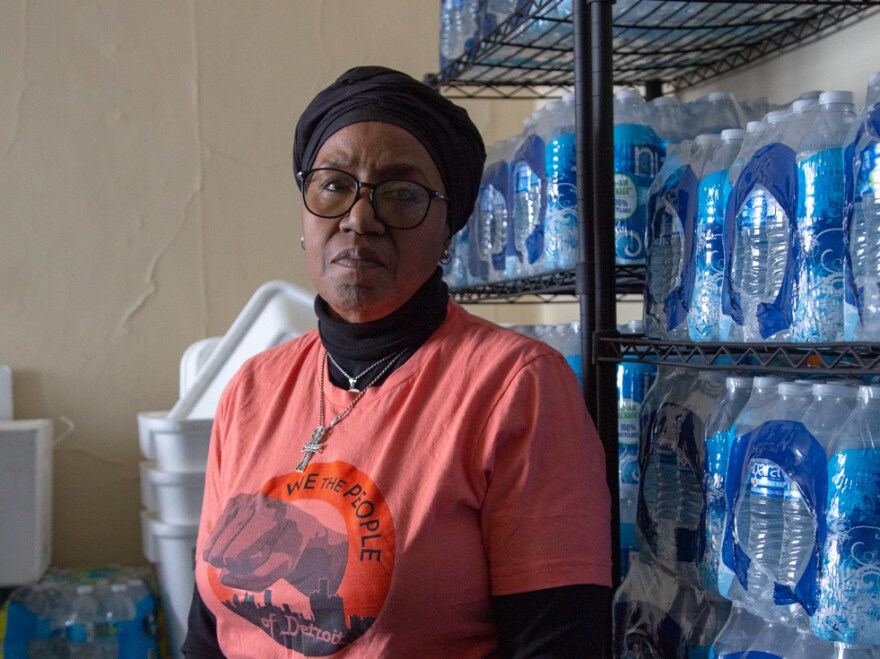 Cecily McClellan stands in a room filled with donated bottled water inside St. Peter's Episcopal Church in Detroit. McClellan is a founding member of We the People of Detroit, which advocates for affordable water.