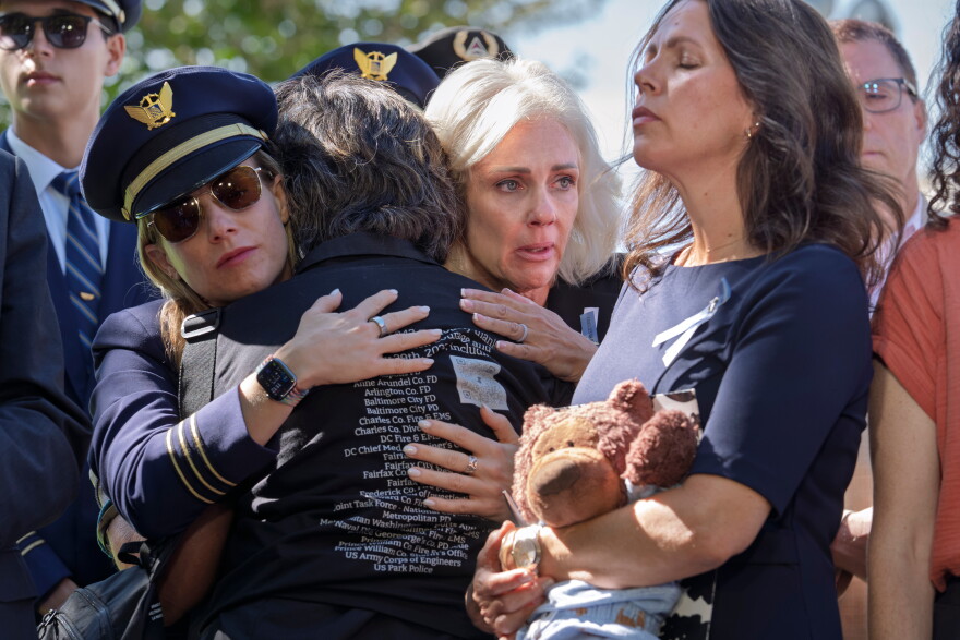 National Transportation Safety Board Chair Jennifer Homendy, center, helps to comfort Christina Stovall, center with back to camera, and Laura Augendre, right, family members of victims of flight 5342, the deadly Jan. 2025 midair collision between an American Airlines plane and a Black Hawk helicopter over the Potomac River, during a news conference on air safety reforms, at the Capitol in Washington, Tuesday, Sept. 15, 2026.