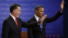 Mitt Romney and President  Obama wave to the audience during the first presidential debate at the University of Denver, on Wednesday.