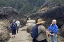 Cape Perpetua Collaborative tidepool leader Jamie Kish leads a group through an intertidal zone during a low tide. Extremely low tides beginning Sunday will reveal even more sea life in the rocky outcroppings along the central Oregon Coast.