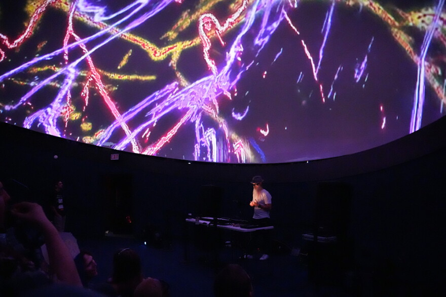 One of the DJs performs during the rave in the Fogg Planetarium on Sept. 11.