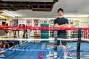 Man stands inside the boxing ring. 