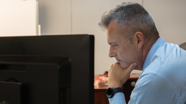 Cocke County Mayor Rob Mathis checks his inbox in his temporary office in a Newport, Tenn. stripmall on Monday, Sept. 8, 2025. After Hurricane Helene dealt irreparable damage to their courthouse and jail, Mathis and other county officials have been struggling to get FEMA to commit to funding a replacement.